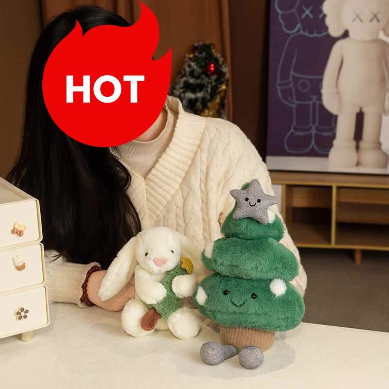Girl hugging a soft white bunny plushie and a fluffy Christmas tree plush for boutique vendors.