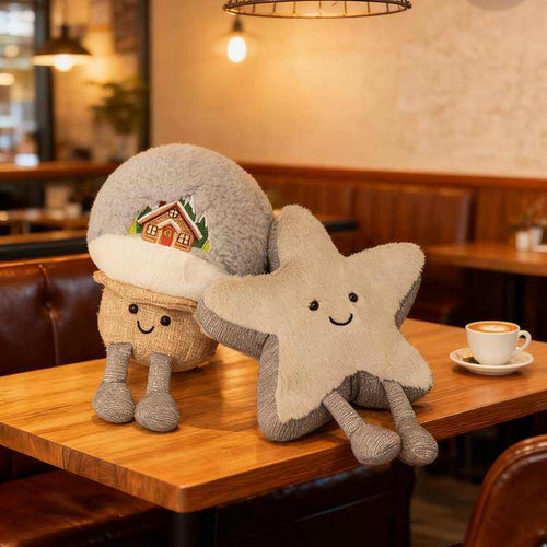 Custom snow cabin and grey star stuffed animals sitting on a wooden cafe table for plush sourcing.