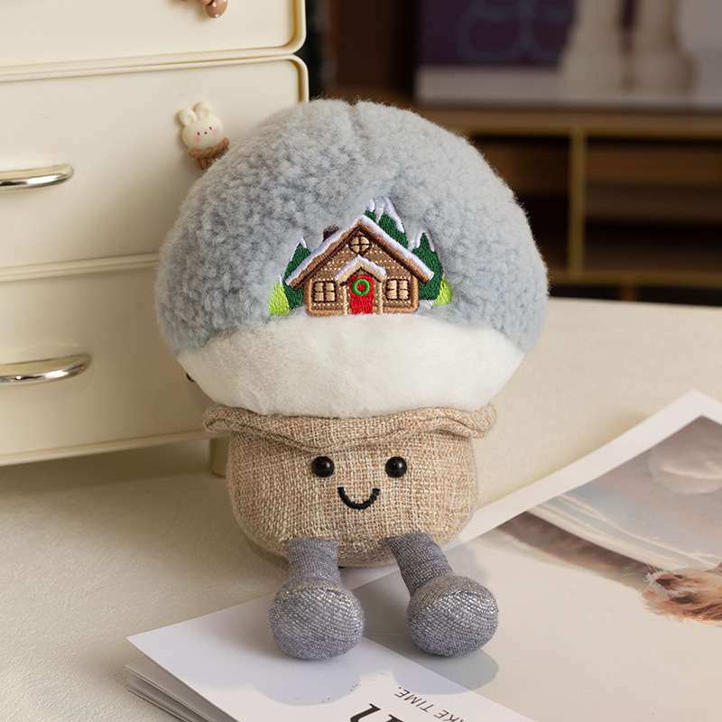 Private-label cozy winter snow house plush with dangling legs resting on a magazine for manufacturers.