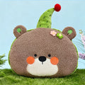 Cute bear plush pillow with green party hat, aesthetic room decor.