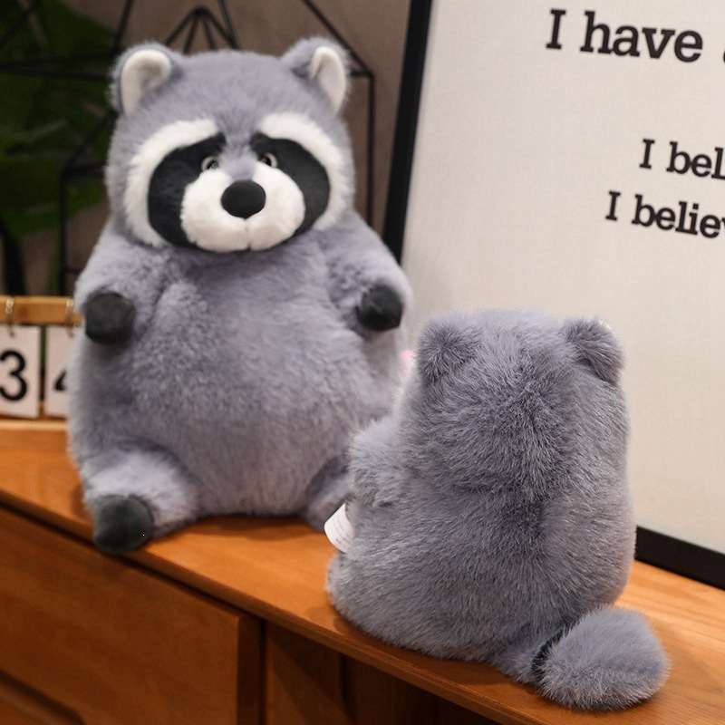 Ready stock chubby raccoon plush doll sitting on a desk, perfect for boutique retail shelves.