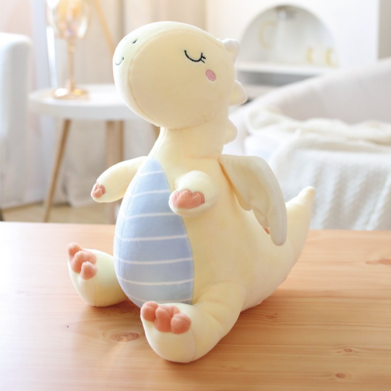 B2B kawaii yellow dinosaur plushie sitting on a wooden table optimized for retail distributors.