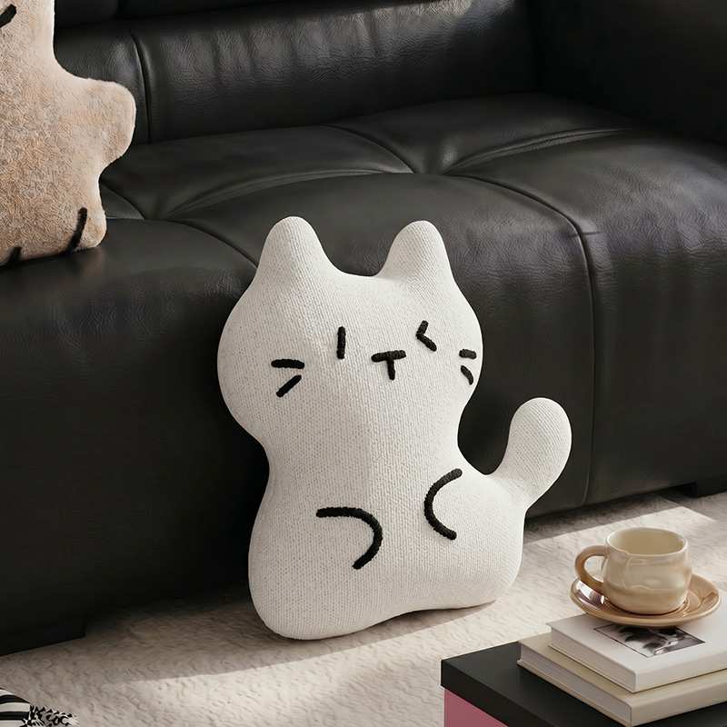 B2B minimalist white cat throw pillow sitting on a rug for boutique home decor suppliers.