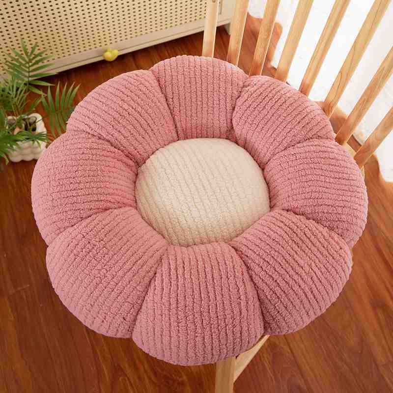 Boutique supply pink flower floor pillow displayed on chair for B2B trade.