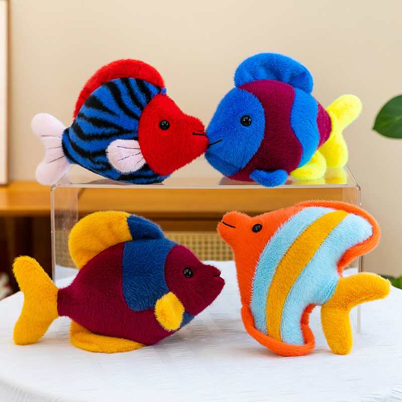 Bulk custom aquarium fish stuffed animals displayed on an acrylic stand for worldwide vendors.