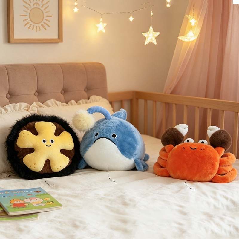 Bulk custom marine life stuffed animal pillows arranged on a bed for nursery decor vendors.