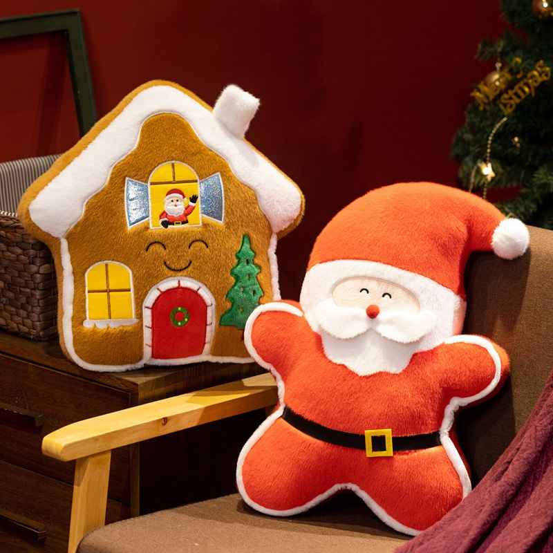 Bulk custom star-shaped Santa and gingerbread house plush pillows sitting on a sofa for vendor sourcing.