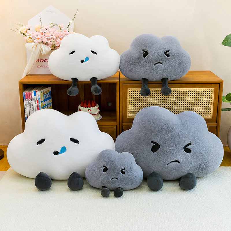 Bulk custom weather cloud cushions in multiple sizes displayed on wooden cabinet for retail vendors.