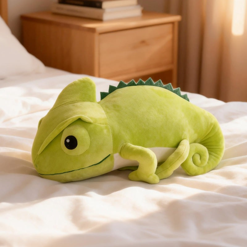 Factory direct bulk green lizard plush toy displayed on a bed for wholesale home decor.