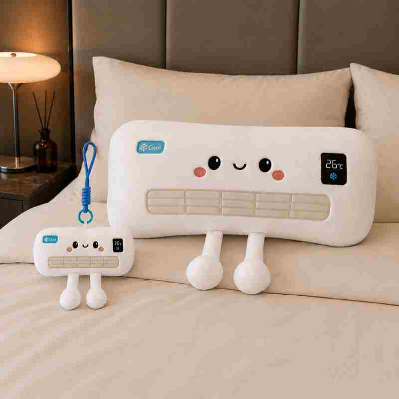 Bulk kawaii air conditioner plush cushion and keychain set displayed on a bed, perfect for summer novelty gifts.