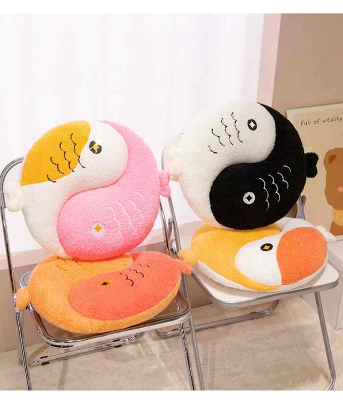 Cute Yin Yang fish plush pillows decorating aesthetic folding chairs in a sunny room.