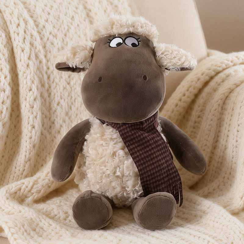 Cozy brown lamb plush toy sitting on a knit blanket for nursery decor wholesale.