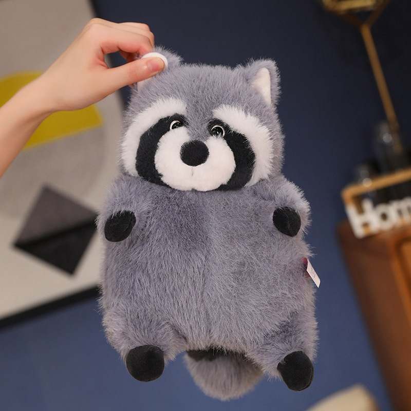 Custom OEM chubby raccoon plushie bag pendant held by hand, ready for global distribution.