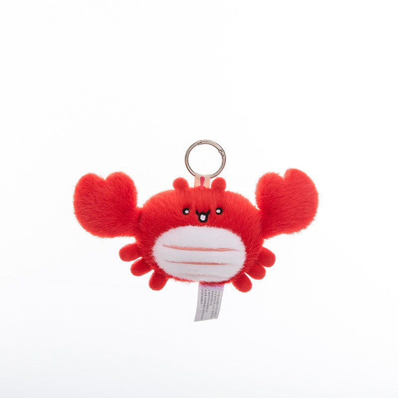 Custom red crab plush bag charm on a wooden tray, optimized for private label toy manufacturer sourcing.