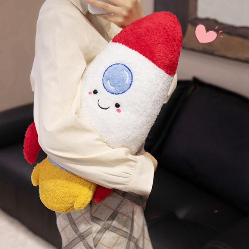 Person holding a large custom rocket ship plush pillow, highlighting OEM manufacturing quality.