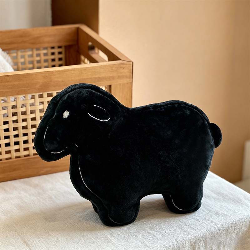 Factory-direct aesthetic black sheep plushie displayed on table for global B2B sourcing.