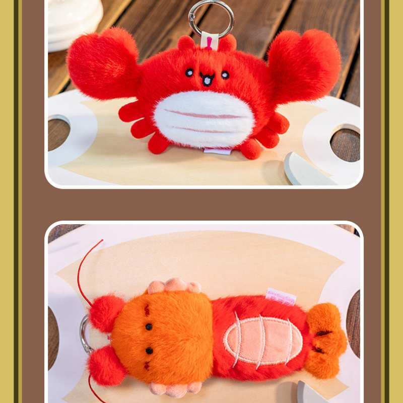 Factory-direct red crab and orange lobster stuffed keyrings displayed on a wooden tray for global B2B sourcing.