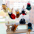 Factory-direct cute insect plush pendants hanging on a line, perfect for gift shop and bookstore impulse buys.