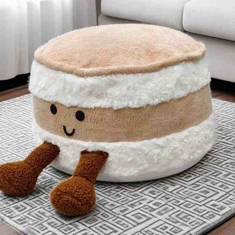 Factory-direct cute macaron floor pillow with dangling legs displayed on a carpet for B2B trade.