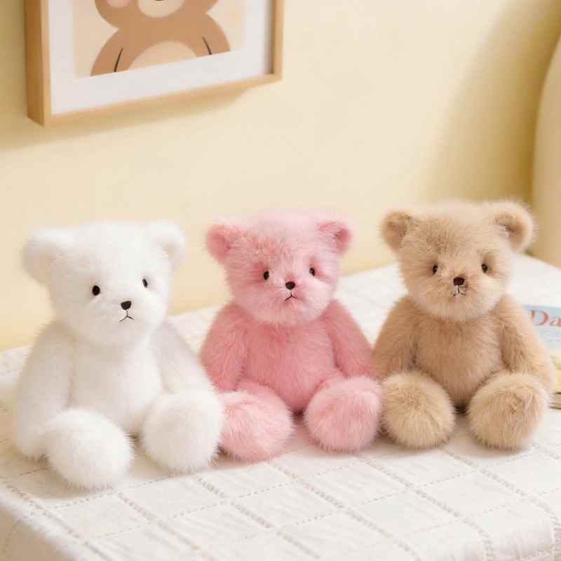 Factory-direct cute plush bears in white, pink, and beige sitting on a table, ideal for premium boutique supply.