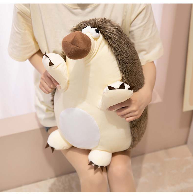Factory-direct giant hedgehog cushion hugged by a model, demonstrating the soft tactile quality and premium feel for novelty gifts.