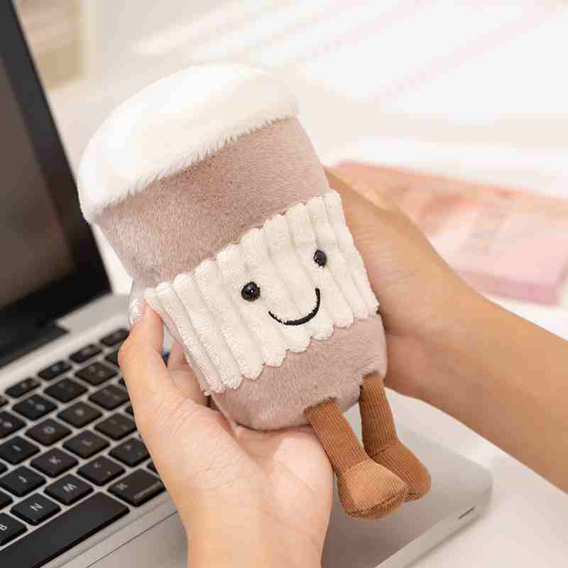 Factory-sourced kawaii coffee cup plush held by a model, demonstrating scale and premium texture for OEM toy vendors.