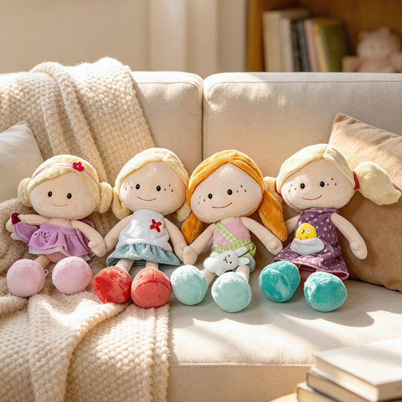 Factory-direct kawaii plush rag dolls lined up on a sofa, demonstrating excellent visual merchandising for retail vendors.