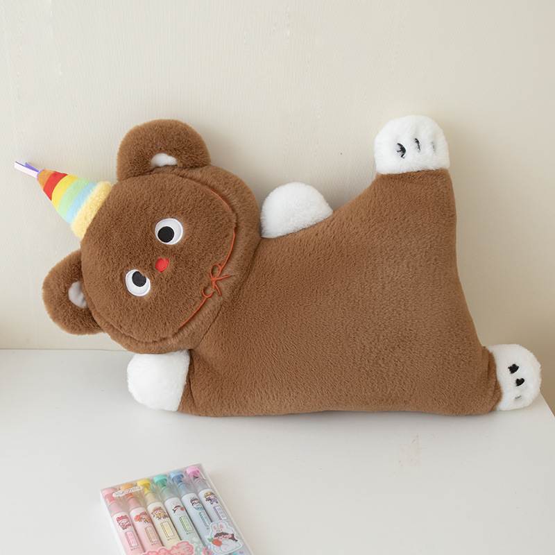 Factory-direct lying brown bear plush cushion wearing a rainbow party hat for wholesale sourcing.