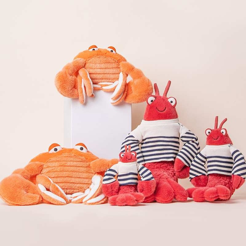 Factory-direct coastal marine life plush collection featuring lobsters in striped shirts and orange crabs.