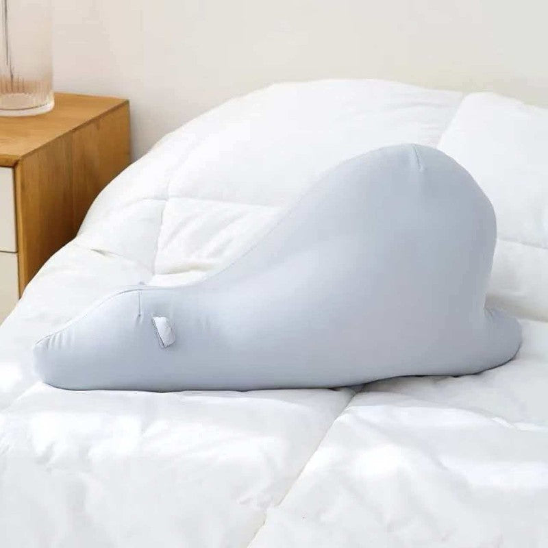 Mochi plush light blue snail body pillow resting on a bed for global B2B toy sourcing.