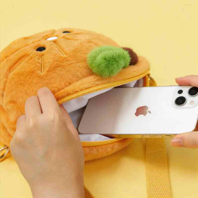 Factory-direct orange plush bag utility size display showing a smartphone fitting inside the zippered compartment for OEM buyers.