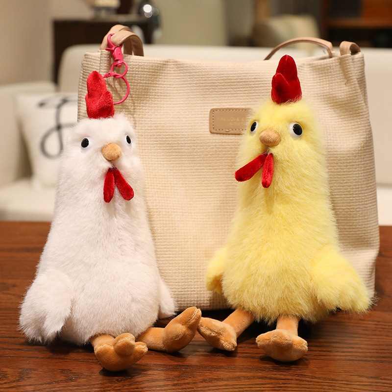 White and yellow fluffy chicken plush toys leaning against a tote bag for factory-direct sourcing.