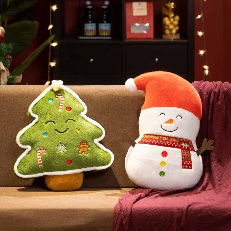 Factory-direct Christmas tree and snowman soft plush toys resting on a couch for holiday sourcing.
