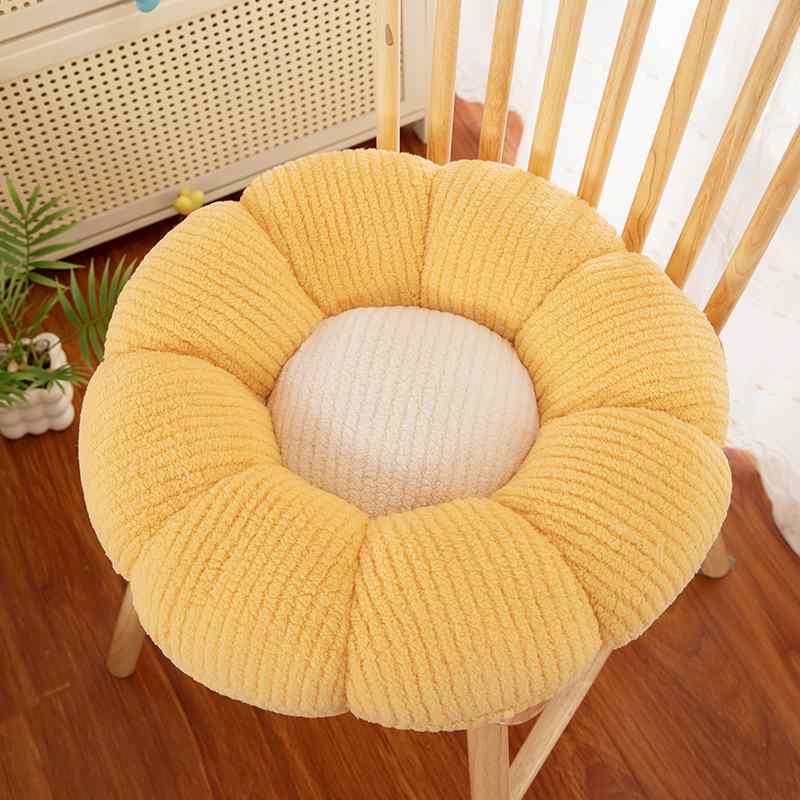 Factory-direct yellow daisy chair pad displayed on wooden chair for B2B sourcing.