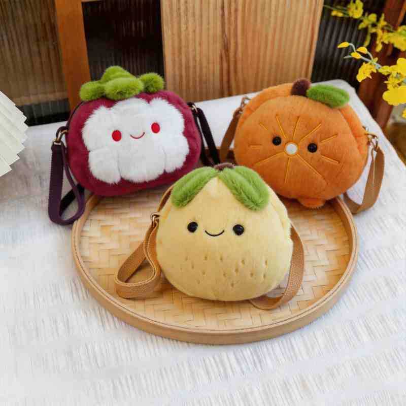High-ROI cute plush coin purses featuring mangosteen, orange, and pear stuffed bags on a bamboo tray for retail distributors.