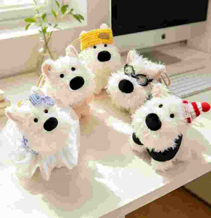 High-ROI dressed dog stuffed animal charms displayed on a desk, ideal for B2B e-commerce accessory catalogs.