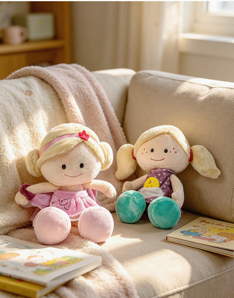 High-ROI plush baby dolls with freckled faces sitting next to children's books, maximizing impulse-buy appeal for nursery decor retail.