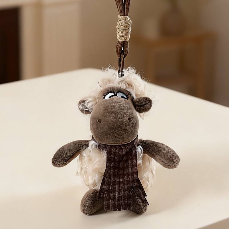 Small brown sheep stuffed animal keyring with scarf on a table for high-ROI distributors.