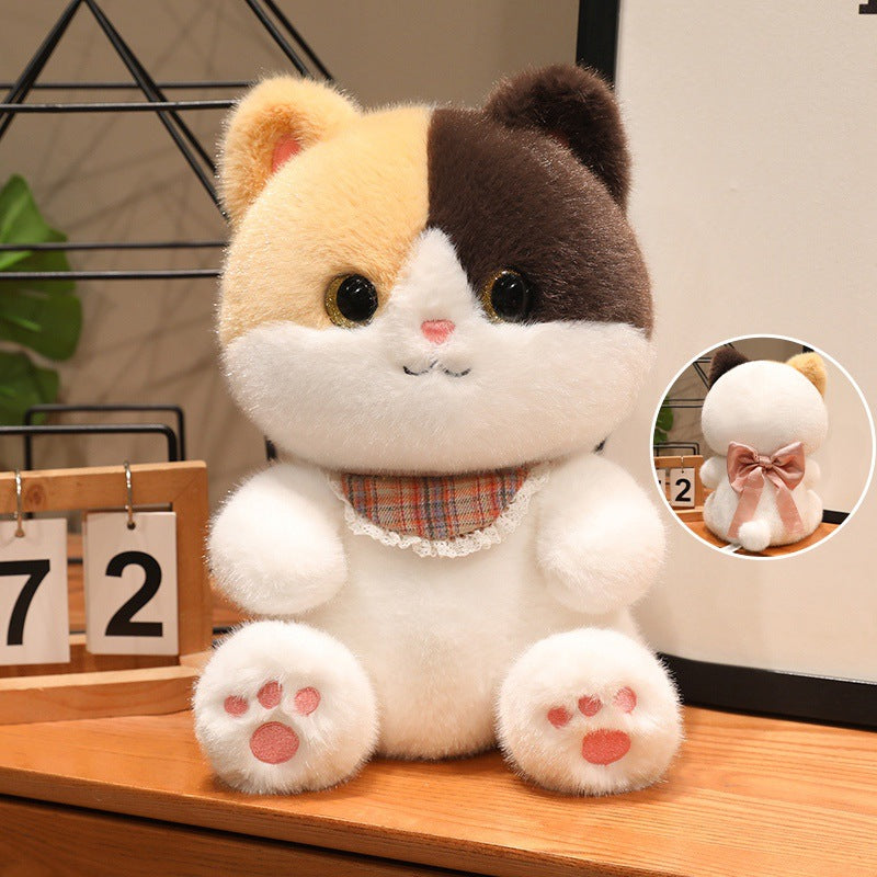 Calico cat plushie with plaid bib and pink bow back view.