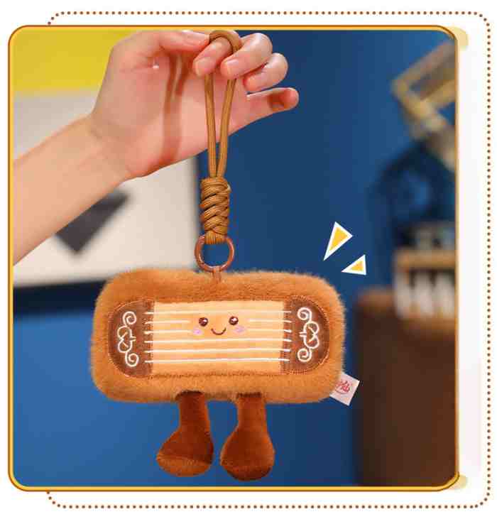 Kawaii musical instrument plush charm with sturdy hook, ready for wholesale claw machine restocking.