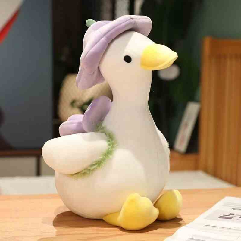 Kawaii yellow flower hat goose plush toy sitting comfortably, showing custom embroidery detailing for OEM sourcing partners.