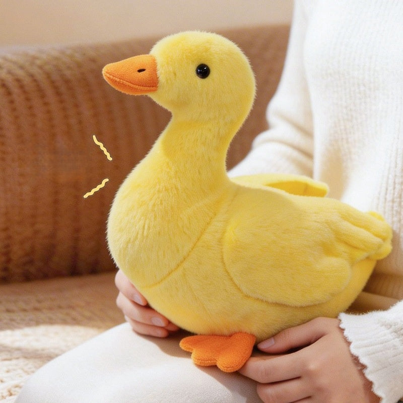 A model holding a 25cm yellow chubby duck plush toy to show the actual size for B2B wholesale buyers.