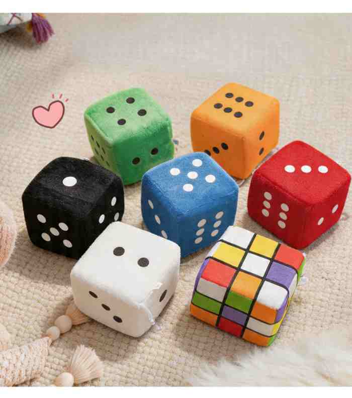 Mixed assortment of colorful plush dice in a bulk carton, ideal for arcade machine restocking.