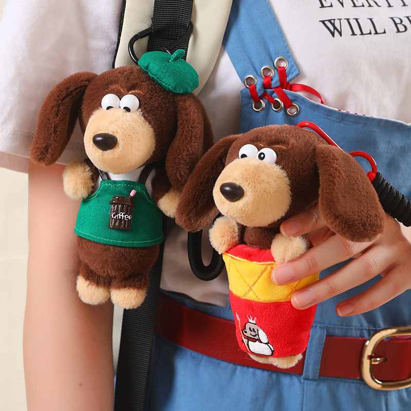 Premium boutique dressed sausage dog keyrings attached to bag straps, ideal for wholesale sourcing distributors.