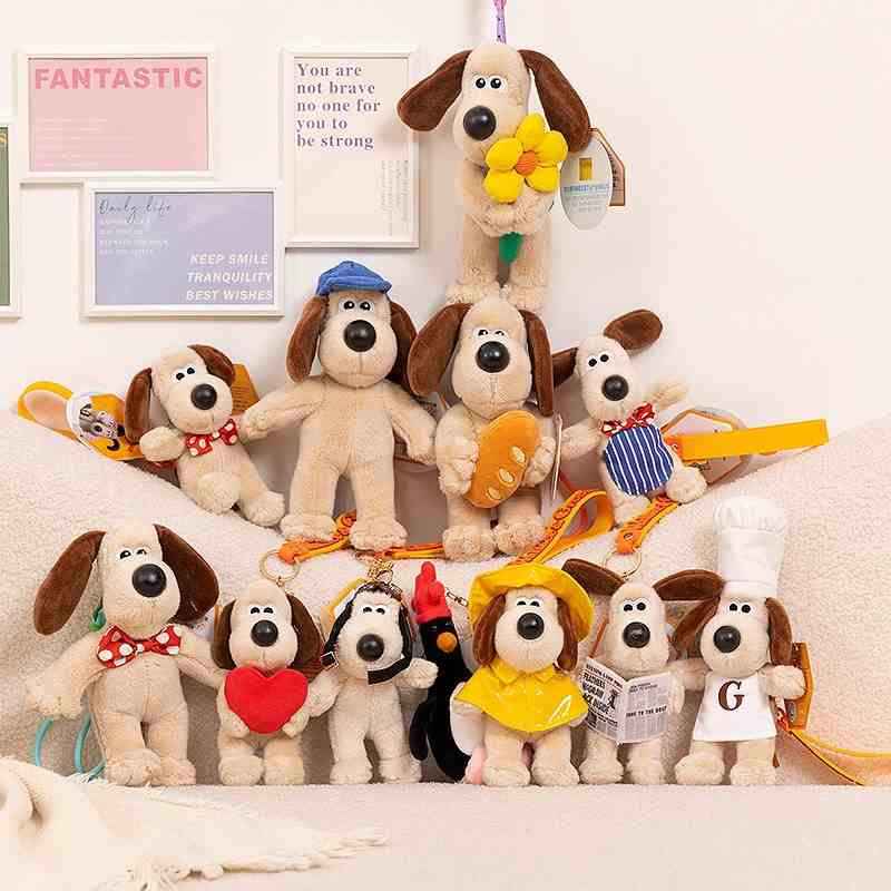 Premium boutique funny dog plush collection display featuring multiple cartoon dressed dog keychains on a sofa for wholesale.