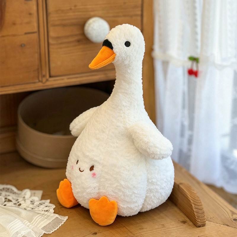 Premium boutique kawaii swan stuffed animal displayed on wooden furniture for retail vendors.