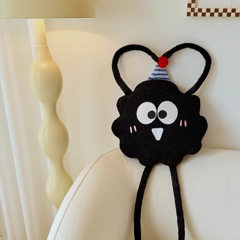 Premium boutique fluffy monster throw pillow with poseable arms making a heart shape for vendor sourcing.