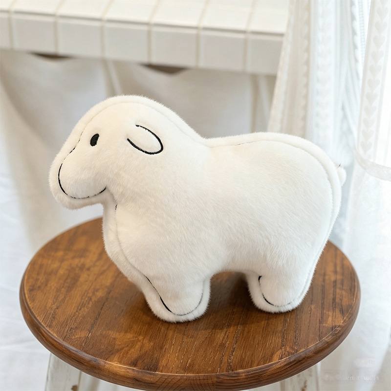 Premium boutique white lamb plush standing on a wooden stool, ideal for nursery decor wholesale.