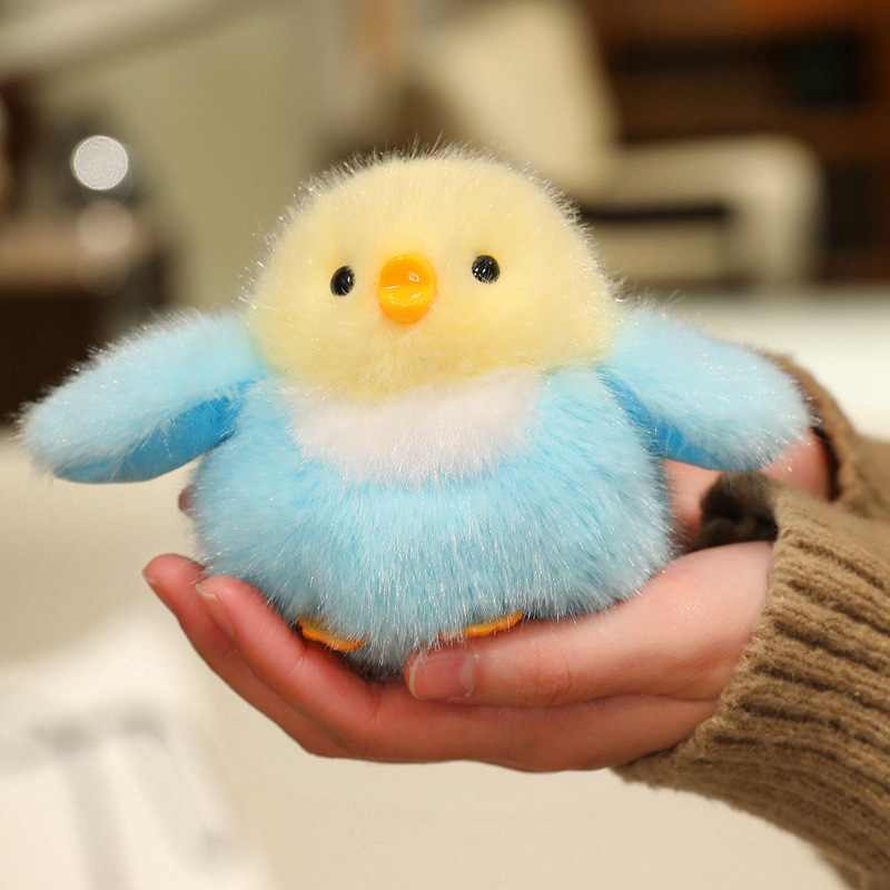 Premium cute blue and yellow bird plush held in hand, designed for boutique wholesale and backpack accessories.