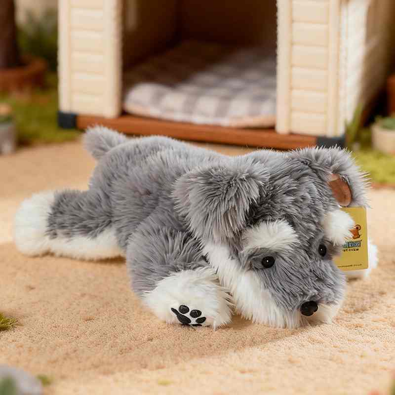 Premium lifelike Schnauzer stuffed animal lying near a doghouse for boutique retail vendors.